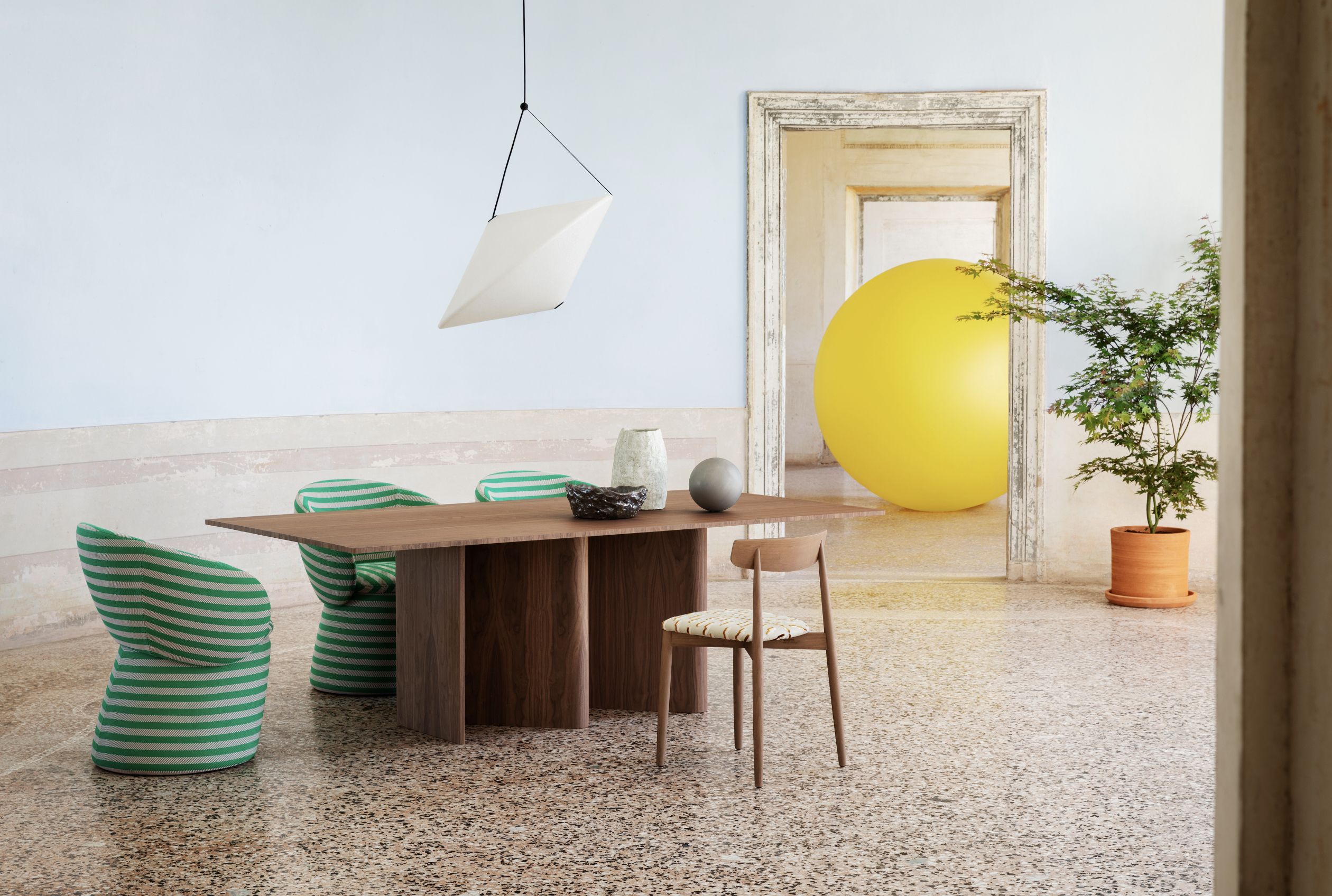 A beautiful wooden table sits in the corner of a cozy room. The furniture is simple yet elegant, adding a touch of sophistication to the space. The property is well-maintained, with carefully placed plants and flowerpots adding a pop of color and life to the room. The table serves as a functional and stylish piece, completing the overall aesthetic of the space.